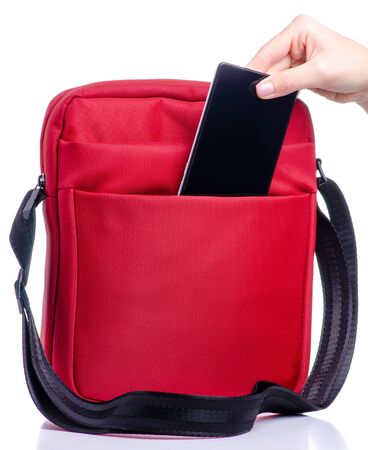 Smartphone put into red messenger bagの写真素材