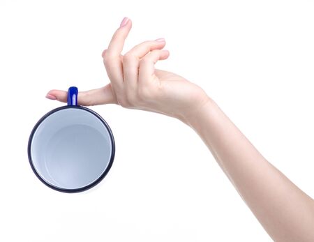 Blue enamel cup in handの写真素材