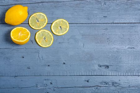 Lemon fruit on blue gray wooden backgroundの写真素材