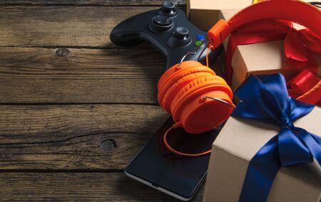 Orange headphones music audio, gamepad, smartphone, mobile phone, box with ribbon bow giftの写真素材