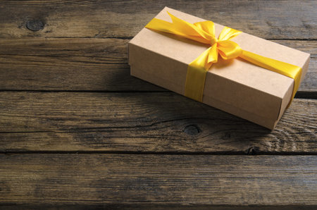 Box with yellow ribbon bow gift