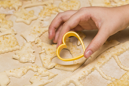 girl cooks biscuits. Baking Christmas cookies. dough and formsの写真素材