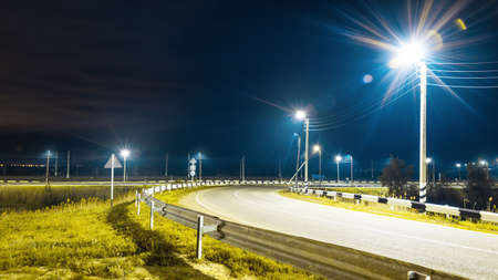 Night road, dark blue sky, green grass, lantern lightingの写真素材