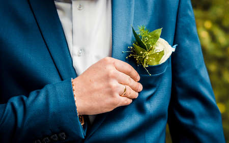 Boutonniere fresh greens, men's hand with a ringの写真素材