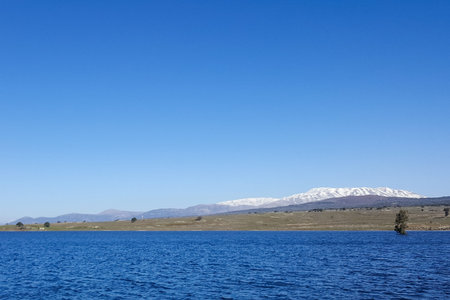 Panoramic beautiful landscape of blue water lake and mountain Hermon as background, Golan Heights,...