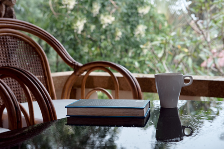 Wicker chair on balcony, cup of coffee and book. Concept calmness, meditation, old age, downshifting. Thailandの写真素材