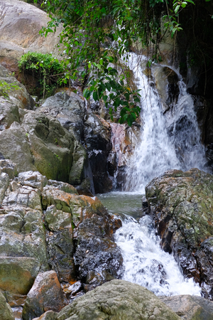 Water powerful stream falls from mountains along rocks. Thailandの写真素材