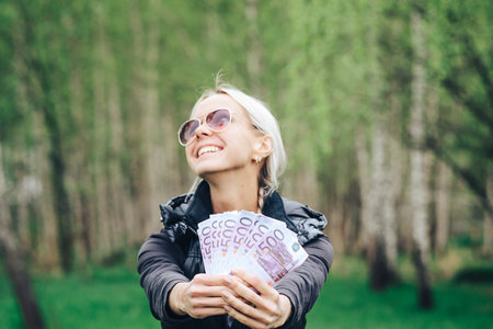blonde made a fan out of a wad of Euros and showing off the money.
