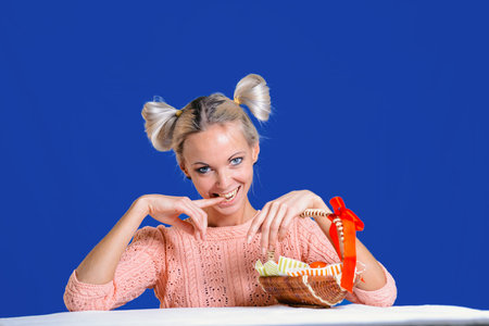 Cheerful girl with Easter eggs on a blue background is ready to celebrate Easter.の写真素材