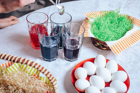 Fresh white eggs on the table with a basket, ready for painting on Easter.の写真素材