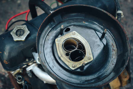 Close-up of an old engine removed from the car and lying near the garage.の写真素材