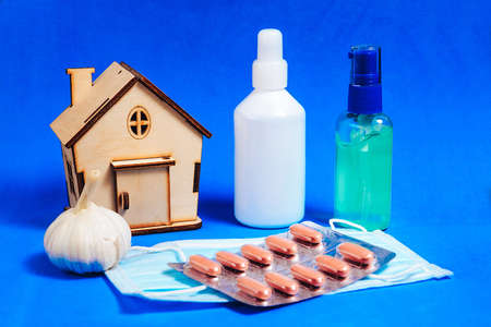 Sterile mask, hand sterilization kit, vitamins, garlic. The concept of basic necessities during home quarantine for colds.の写真素材