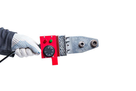 Professional soldering iron for plastic pipes in hand, close-up, white isolated background.の写真素材