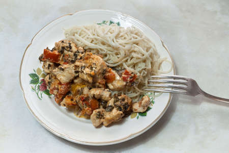spaghetti with chicken in cream sauce with tomatoes and Basilの写真素材