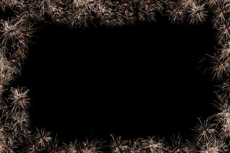 Christmas frame from fireworks with a black backgroundの写真素材