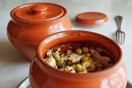 Meat with vegetables and spices in a clay potの写真素材