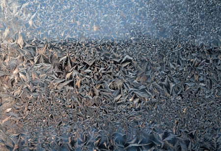 glittering frosty pattern on glass closeup