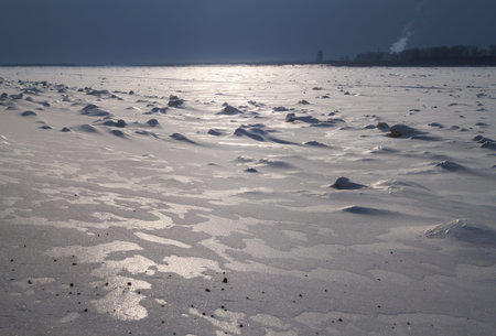 frozen river covered with snow and the icy crust