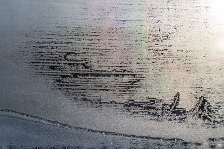 glittering frosty pattern on glass closeupの写真素材