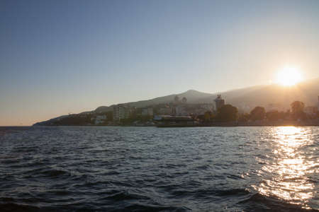 view from the water at the setting sunの写真素材