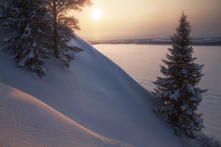 view from the hill to the winter valley at sunsetの写真素材