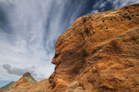 mountain compressed sawdust in the shape of a face against a blue skyの写真素材
