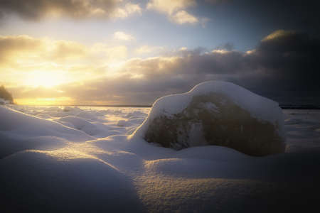 blocks of ice on the river at sunsetの写真素材