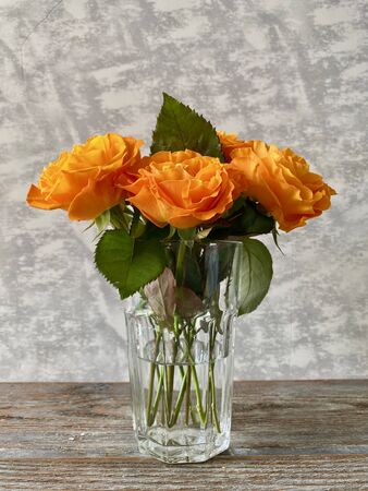 Roses in a clean glass, on a gray backgroundの写真素材