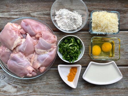 Products for cooking meat and chicken cutlets are spread out on a wooden table. Ready to cook in the kitchenの写真素材