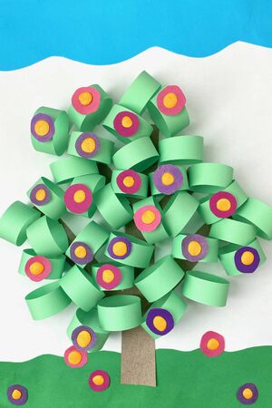 light, children's creativity, a Bush with flowers made of colored paper.の写真素材