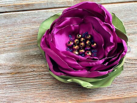 Flower made of pink fabric, made using candle burn, craft for women at home.の写真素材