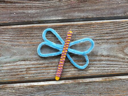 dragonfly, childrens needlework from pipe cleaners and wooden sticksの写真素材
