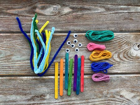 Set for childrens creativity, pipe cleaners, plastic eyes and yarn, ready for needlework.の写真素材
