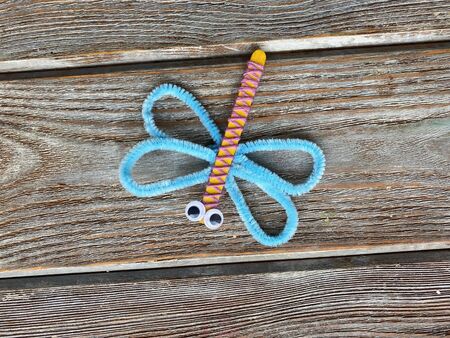 Dragonfly with blue wings and plastic eyes, childrens craftの写真素材