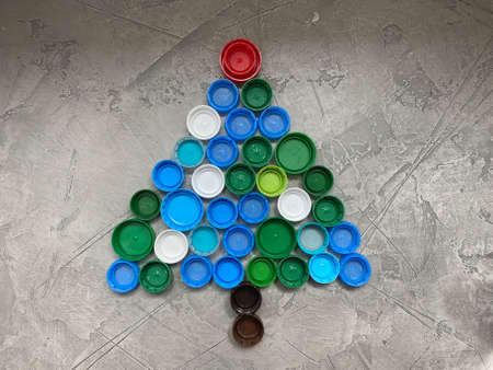 Christmas tree made of recycled plastic lids, on a gray backgroundの写真素材