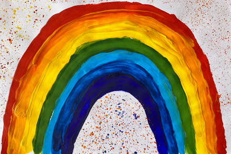 Clean children's hands on the background of white sheet and multi-colored paintの写真素材