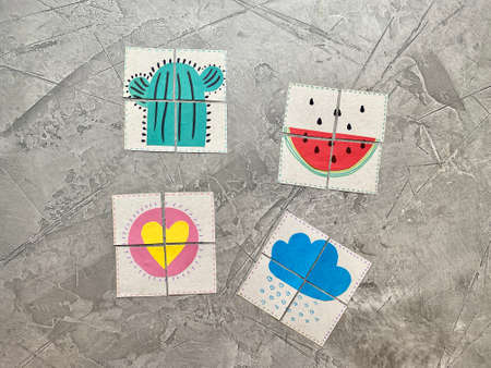 Childrens logic puzzle, bright pictures cut into 4 parts, an idea for home games.の写真素材