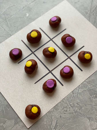 Childrens game TIC TAC toe made of chestnuts and plasticineの写真素材