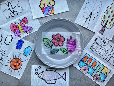 Childrens craft, magic trick, image appears in a plate of water, child art.の写真素材