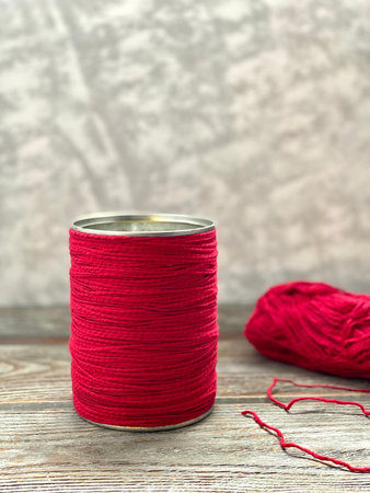 Recycling tin can, wrapped with red thread, for kids craft.