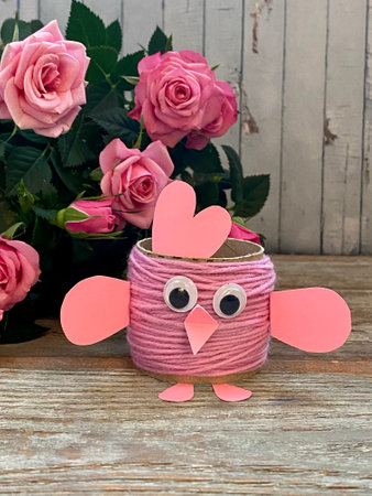 Pink chicken from yarn and processing-Easter egg stand, childrens creative.の写真素材