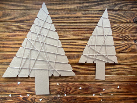 instructions for new years childrens craft, Christmas tree made of cardboard and yarn.の写真素材