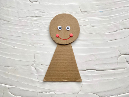 Kids craft, how to make a doll out of cardboard and plasticine.の写真素材