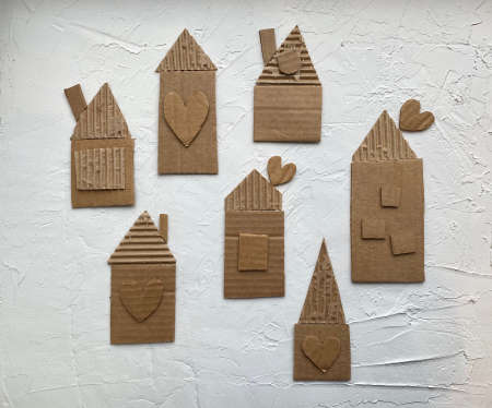 kids craft application of cardboard and corrugated cardboard houses with windowsの写真素材