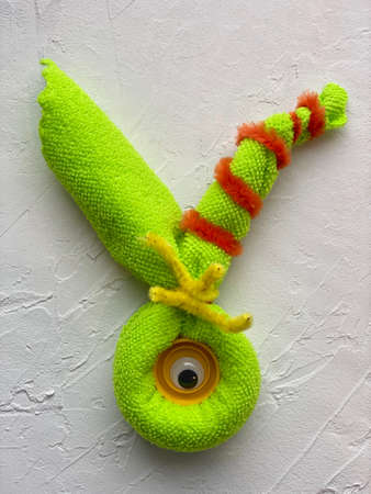 Cute green monster with one eye made of microfiber cloth and rubber bands, kids craftの写真素材
