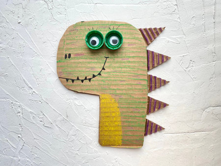 Dino made of cardboard, creativity for children made of simple materialの写真素材