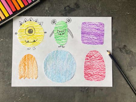 Draw funny monsters on paper with a pencil. Lesson learning for children.の写真素材