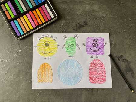 Draw funny monsters on paper with a pencil. Lesson learning for children.の写真素材