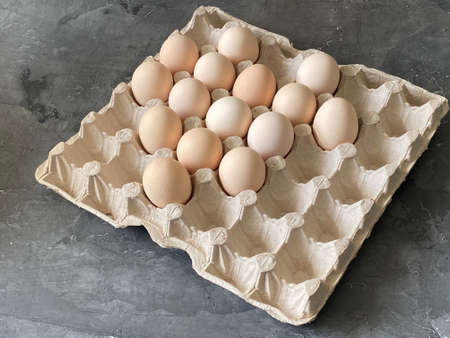 A light box of a square shape with eggs, on a gray background.の写真素材