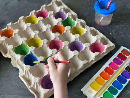 Childrens hands paint the egg box, recycling,の写真素材